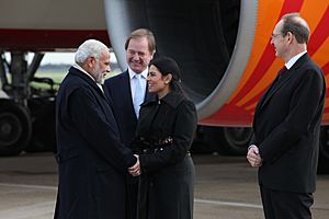 Narendra Modi is greeted by British MP Priti Patel after arriving at Heathrow Airport