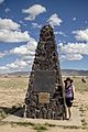 Tourist Standing Next to Trinity Site Monument or Obelisk