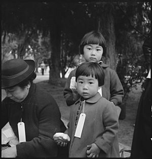 Two Children of the Mochida Family, with Their Parents, Awaiting Evacuation Bus (3679508964)
