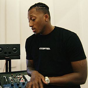Lecrae sitting in a recording studio.jpg