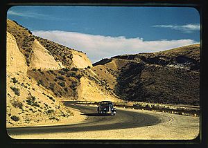 Road cut into the barren hills which lead into Emmett. Emmett, Idaho, July 1941