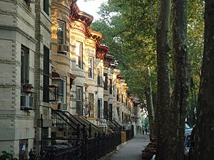Row houses in alternating cream, yellow, and gray brick, in Bushwick, Brooklyn