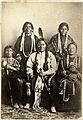 Sitting Bull and family 1881 at Ft Randall rear L-R Good Feather Woman (sister), Walks Looking (daughter) front L-R Her Holy Door (mother), Sitting Bull, Many Horses (daughter) with her son, Courting a Woman