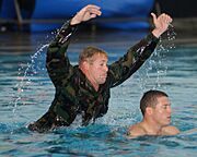 US Navy 030503-N-8209D-086 A Basic Underwater Demolition-SEAL (BUD-Sea, Air, Land) Instructor is about to show a member of BUD-S Class 244 just how hard it can be to rescue a drowning victim