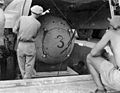 Fat Man test unit being raised from the pit into the bomb bay of a B-29