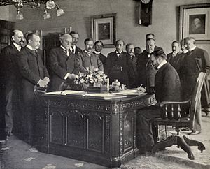 John Hay signs Treaty of Paris, 1899