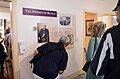 People reading wall graphic “The Primacy of Reason,” banner-35