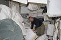 STS-135 Doug Hurley moves around supplies and equipment in the Leonardo PMM