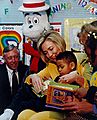 Clinton reads a book to an African-American grade-schooler in Maryland during Read Across America Day in 1998
