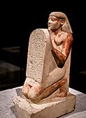 Kneeling portrait statue of Amenemhat holding a stele with an inscription 01