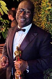 Steve McQueen holding Best Picture Oscar 2014 (cropped)