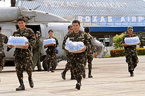 US Navy 080626-N-5961C-003 Servicemen of the Philippine Army transport bottled water from an SH-60 helicopter assigned to Helicopter Anti-Submarine Squadron (HS) 4 at Roxas airport