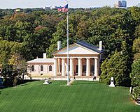 Mansion with columns and a flagpole
