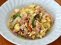 Phat naem sai khai is a dish consisting of naem stir-fried with egg.