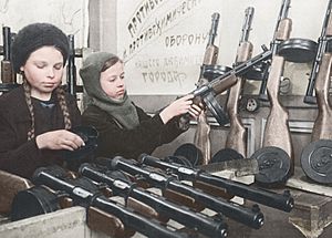 Two little girls assemble submachine guns during the siege of Leningrad, 1943. (46089025944)