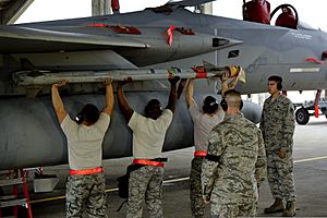 U.S. Airmen with the 67th Aircraft Maintenance Unit install a missile on an F-15 Eagle aircraft during a weapons load competition April 5, 2013, at Kadena Air Base, Japan 130405-F-FL836-208