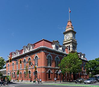Exterior view of red-brick Victoria City Hall with clock tower