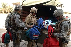 301st PSYOP Company, USAR, Calif., and 3-7 Cavalry, Fort Stewart, Ga., soldiers give away school supplies in Safia Bint Abdul Mutaleb School in 2007
