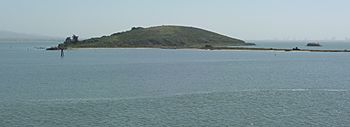 A gray, dome-shaped island rises out of the water.