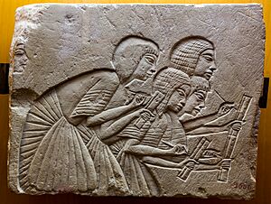 Fragment of tomb relief depicting four scribes at work