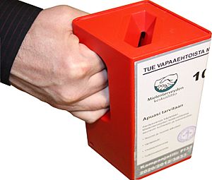 Hand holding a red fundraising box