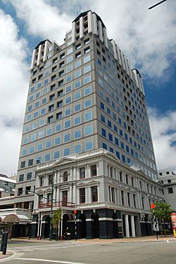 A modern high rise building with a historic façade around the lower stories