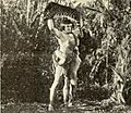 Tarzan holding a tiger corpse above his head