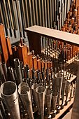 Casavant Frères ranks of round, grey metal pipes and square wooden pipes of all sizes inside one of the swell boxes inside the organ.
