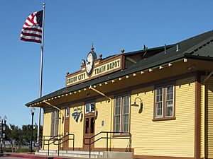 American flag flies in front of Suisun City Train Depot