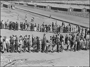 Dorothea Lange - American internees in mess hall line at Tanforan Assembly Center San Bruno CA April 29 1942