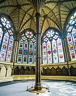 A large, octagonal room with stained-glass windows and a central pillar