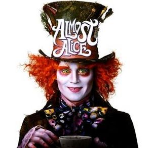 The mad hatter staring directly at the viewer holding up a cup of tea.