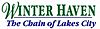 Winter Haven in a green serif font on top except for a cursive W, "The Chain of Lakes City" on bottom in an italicized sans serif font