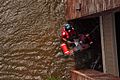 United States Coast Guard Scott D. Rady pulls a pregnant woman from her flooded New Orleans home