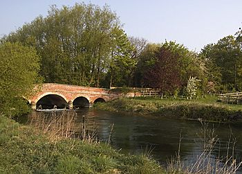 A jumped red-brick bridge over a river