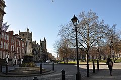 View of College Green showing Queen Victoria statue, Cathedral and Council House, with restored cast iron lamp post in foreground