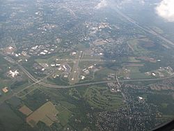 Aerial view of Ewing, looking southeast. Trenton-Mercer Airport, Interstate 295 and the Delaware River are prominent in the photo.