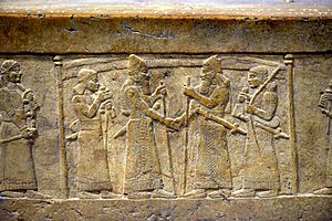 Shalmaneser III greets Marduk-zakir-shumi, detail, front panel, Throne Dais of Shalmaneser III at the Iraq Museum