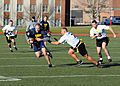 US Navy 111202-N-FC065-001 Cmdr. Bill Mallory tries for more yards after a reception during a flag football game celebrating the annual Army-Navy f