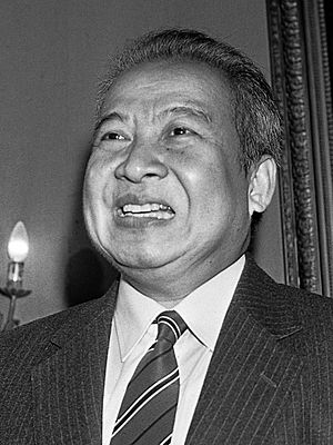 A black-and-white photograph of Sihanouk smiling