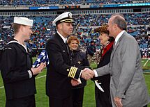 US Navy 041227-N-6631E-001 Commanding officer of the aircraft carrier USS John F. Kennedy (CV 67), Capt. Dennis E. FitzPatrick shakes hands with Jacksonville Jaguar owner Wayne Weaver