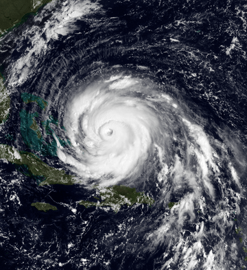 A view of Hurricane Floyd from Space on September 13, 1999. The storm is mature and well-defined, with a pronounced eye feature. Floyd is located over the Atlantic Ocean, and to the north and east of Cuba and Florida, respectively.