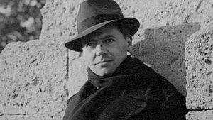 Jean Moulin with a scarf and fedora by Marcel Bernard