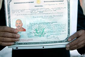 Juan Alameda holding up his certificate of derivative citizenship
