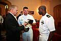 US Navy 090904-N-3271W-024 Ensign Dewayne Thomas and Chief Missile Technician Chad Ownbey, both assigned to the guided-missile submarine USS Ohio (SSGN-726), present Ohio Governor Ted Strickland with a command ball cap