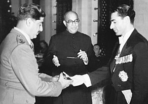 Lt. Col. Agha Mohammad Yahya Khan presents the crest of the Baloch Regiment to the Shah of Iran as Prime Minister Liaquat Ali Khan watches
