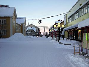 The main street (Storgatan) and December 2005 snow and Christmas lights in Gällivare at about noon.
