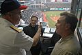 US Navy 060828-N-1805P-007 Chief of Naval Personnel Vice Adm. John C. Harvey Jr. chats with broadcasters from Cleveland radio station WTAM 1100 AM during a Major League Baseball game at Jacobs Field between the Cleveland Indian