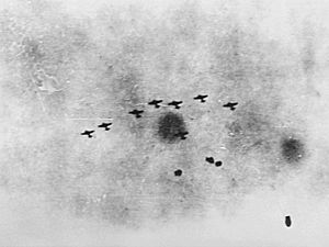 A formation of Japanese bombers attacking warships in the Java Sea