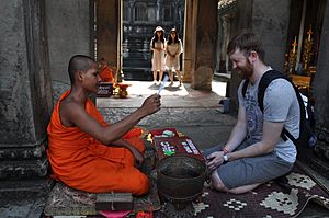 Buddhist monk and tourist at Angkor Wat